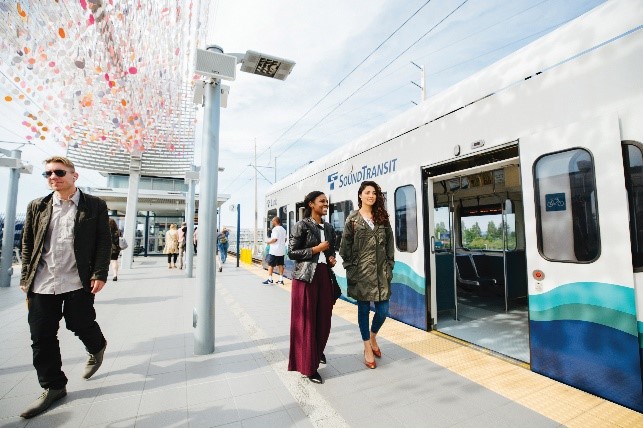 Passengers at a Link station, waiting to board the train.